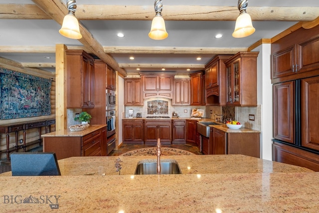 kitchen with a warming drawer, decorative backsplash, appliances with stainless steel finishes, a sink, and light stone countertops