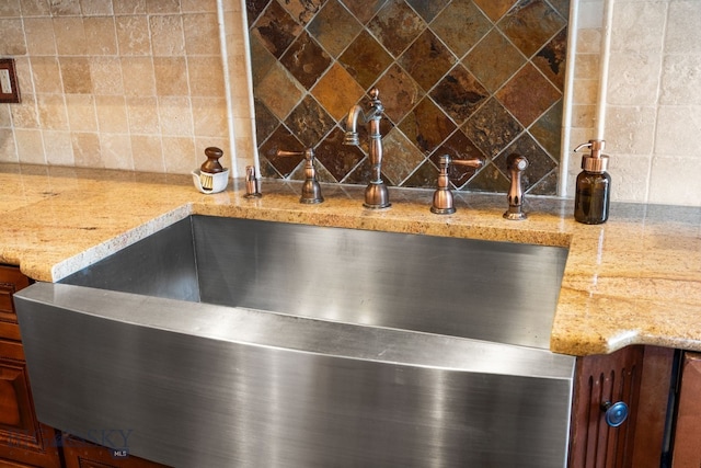 interior details with a sink and backsplash