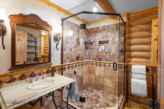 full bath with a sink, rustic walls, and a shower stall