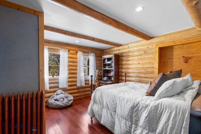 bedroom with hardwood / wood-style flooring, radiator heating unit, beamed ceiling, log walls, and recessed lighting