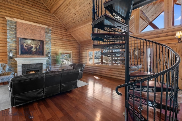 living room featuring a warm lit fireplace, high vaulted ceiling, hardwood / wood-style floors, and log walls