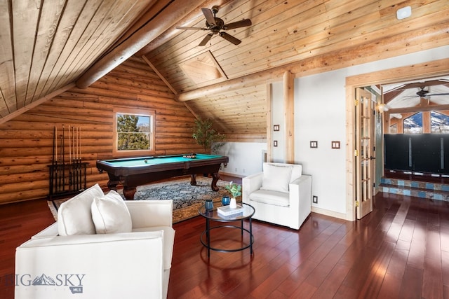 recreation room with dark wood finished floors, rustic walls, lofted ceiling with beams, a ceiling fan, and wood ceiling