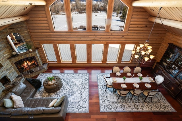 living room with hardwood / wood-style flooring, wooden ceiling, a fireplace, and an inviting chandelier