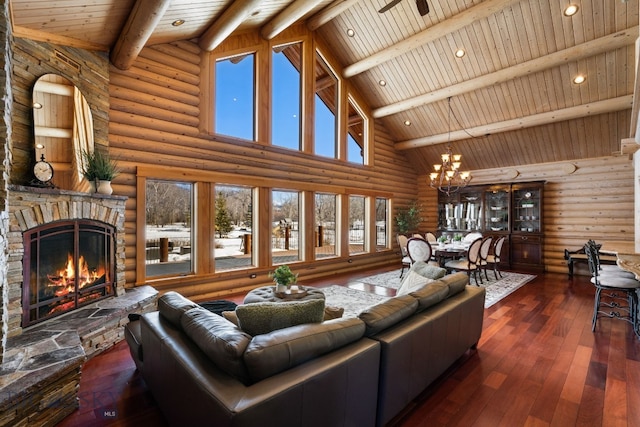 living area with wooden ceiling, hardwood / wood-style flooring, beamed ceiling, and a stone fireplace