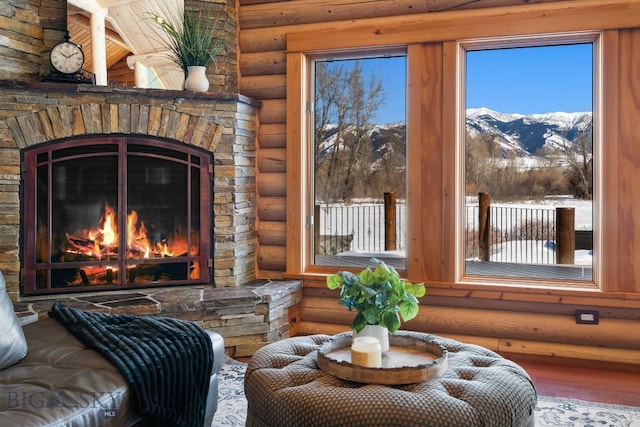 living area with a fireplace and a mountain view