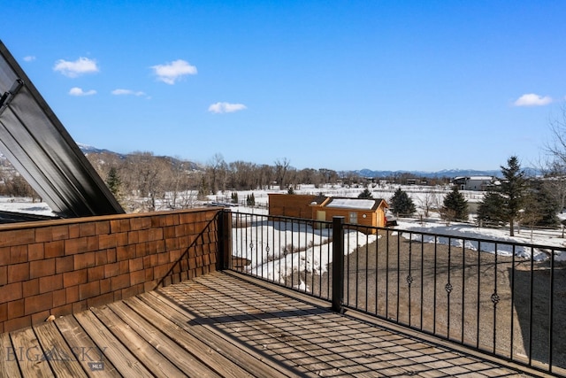 snow covered deck featuring a mountain view