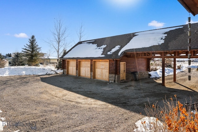 exterior space with a detached garage