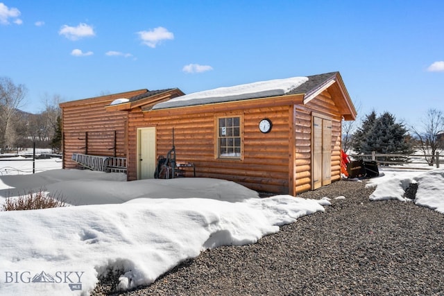 log cabin featuring log veneer siding