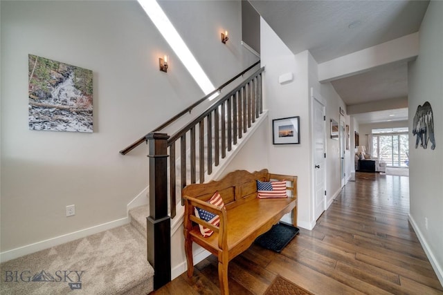 interior space featuring baseboards and wood finished floors