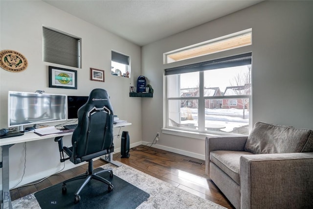 office featuring visible vents, baseboards, and wood finished floors