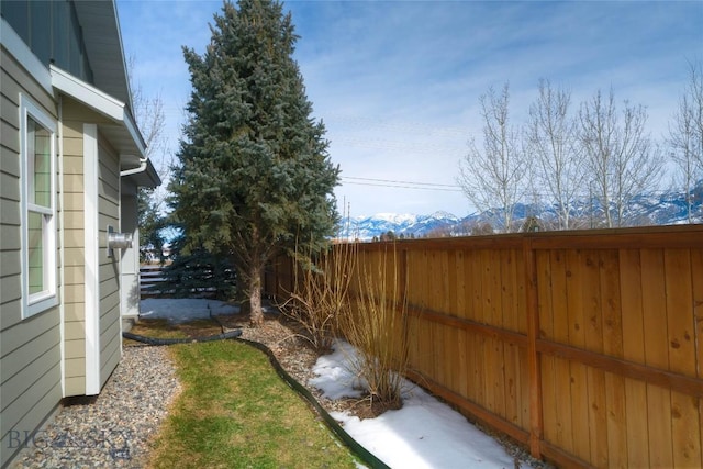 view of yard featuring a mountain view and a fenced backyard