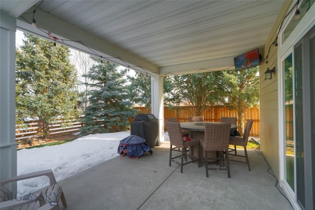 view of patio featuring outdoor dining area, grilling area, and fence