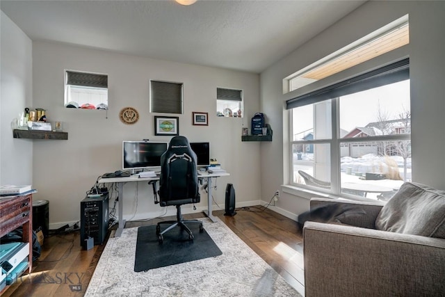 office area with baseboards and hardwood / wood-style flooring