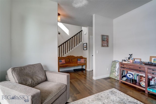 interior space featuring hardwood / wood-style flooring, stairway, and baseboards