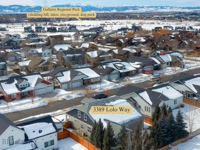 snowy aerial view featuring a residential view