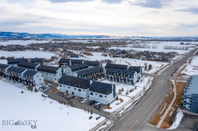 snowy aerial view with a mountain view