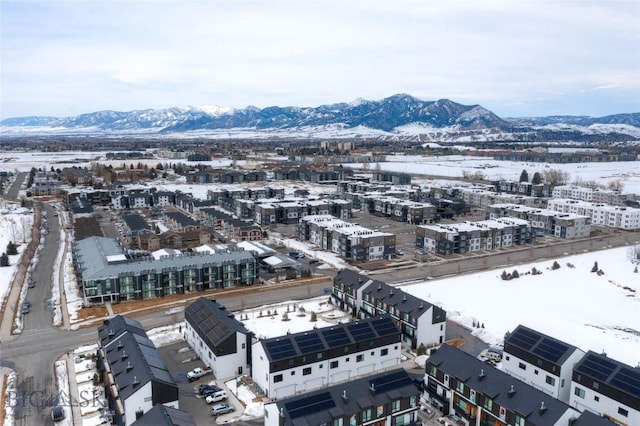 snowy aerial view with a mountain view