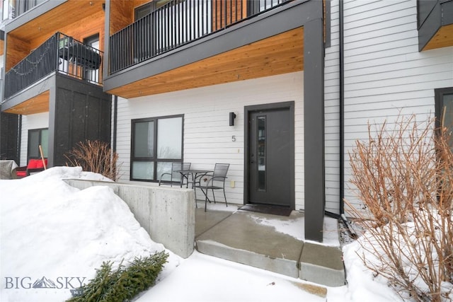 view of snow covered property entrance