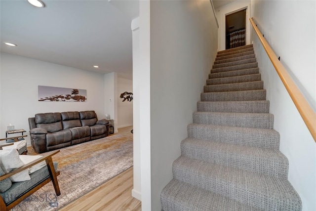 staircase featuring recessed lighting and wood finished floors