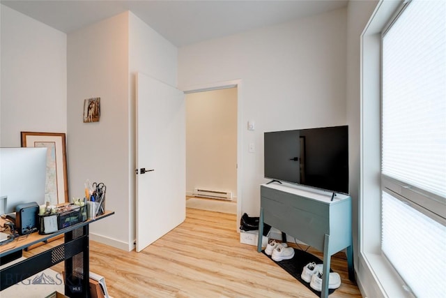 office featuring a baseboard heating unit and light wood-style flooring