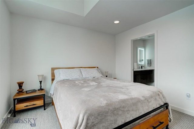 bedroom with recessed lighting, light colored carpet, connected bathroom, and baseboards