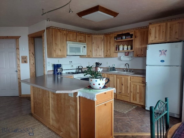 kitchen featuring dark tile patterned floors, white appliances, open shelves, and a sink