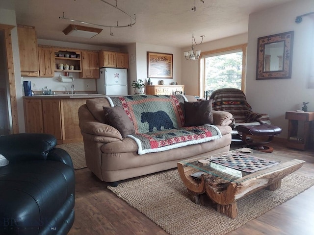 living room with a notable chandelier and wood finished floors