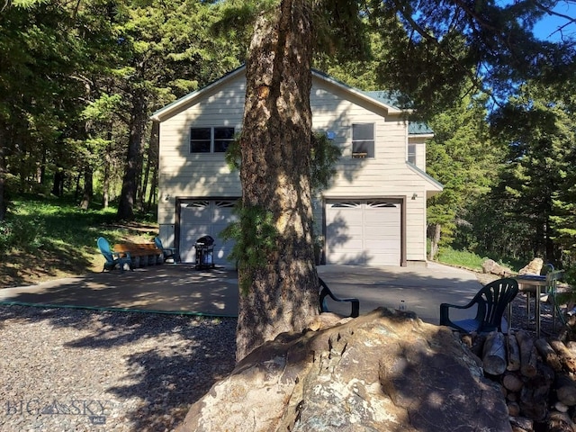 view of side of home featuring a garage