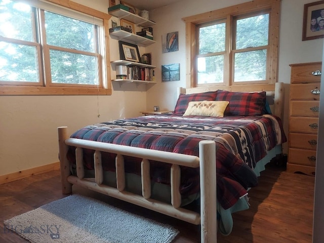 bedroom featuring baseboards and wood finished floors