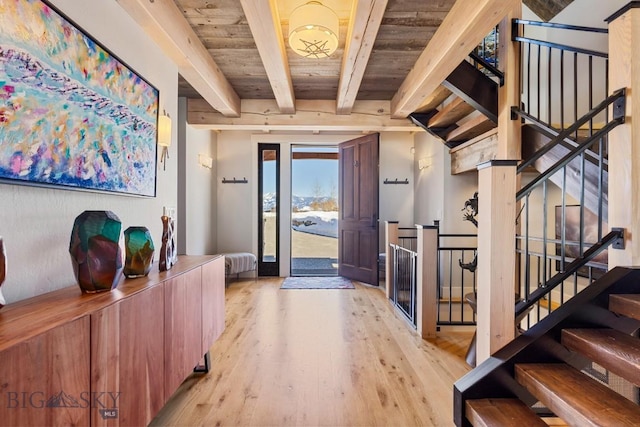 entryway featuring stairs, wooden ceiling, beamed ceiling, and light wood-type flooring