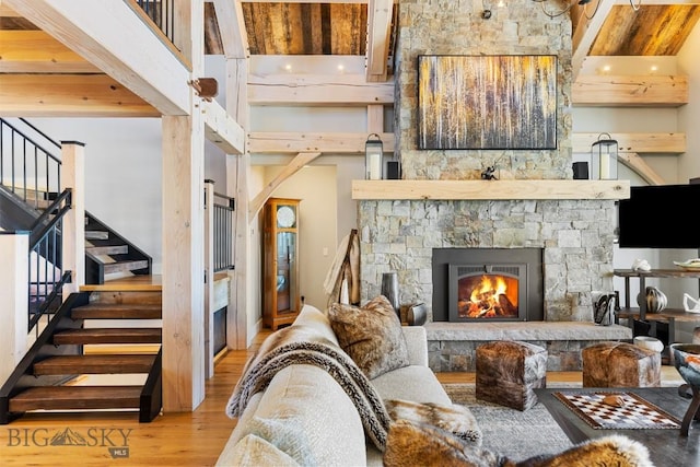 1468 Black Bull Trl, Bozeman, MT 59718 - living room featuring wood finished floors, stairway, and a fireplace