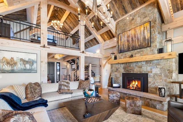 living room with stairs, wooden ceiling, a fireplace, and an inviting chandelier