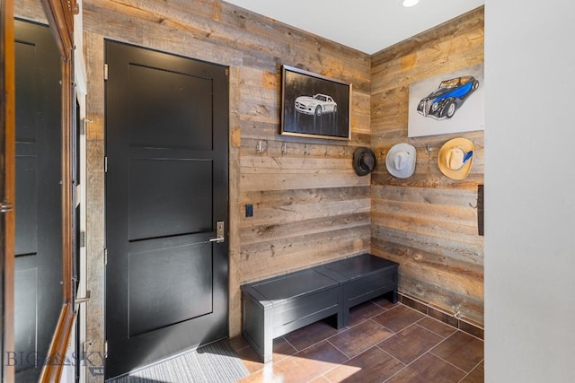 mudroom featuring wood walls