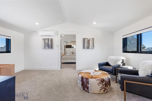 sitting room with baseboards, carpet floors, vaulted ceiling, and a wall mounted AC