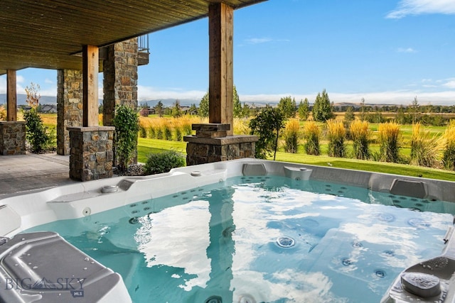 view of pool with a hot tub