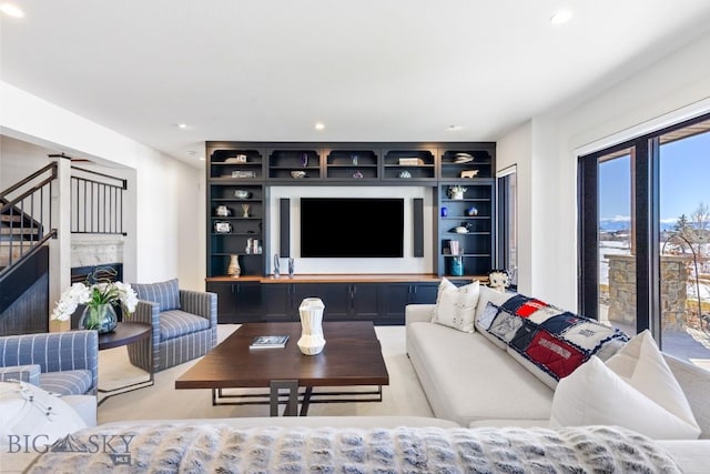 living room with recessed lighting, stairs, and a fireplace