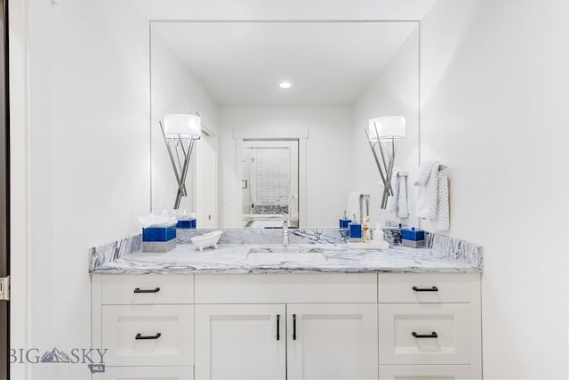 bathroom featuring vanity and recessed lighting