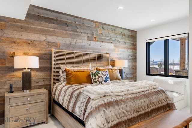 bedroom with recessed lighting and wood walls