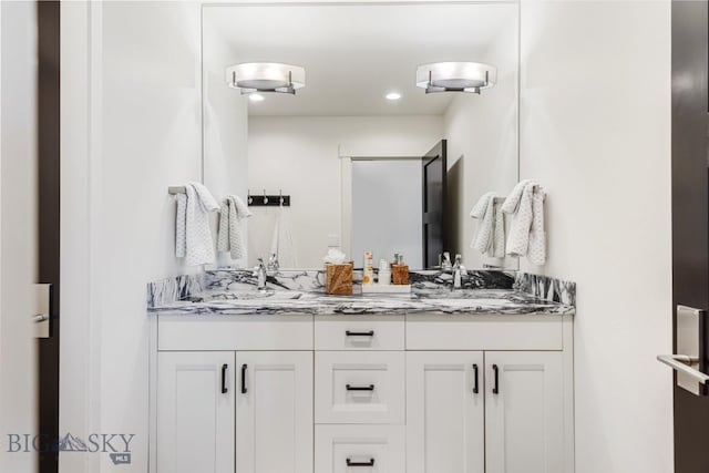 full bathroom with a sink and double vanity