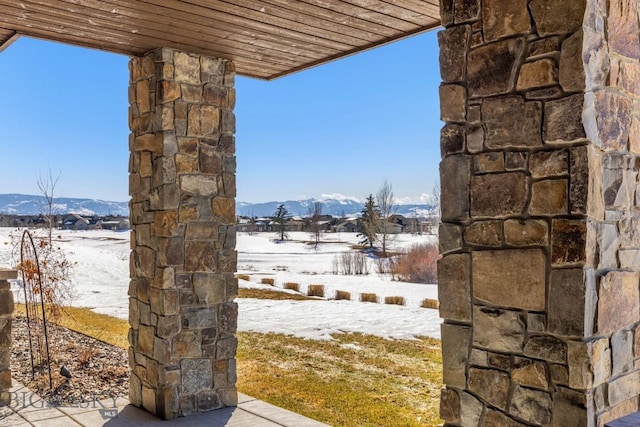 snow covered patio featuring a mountain view