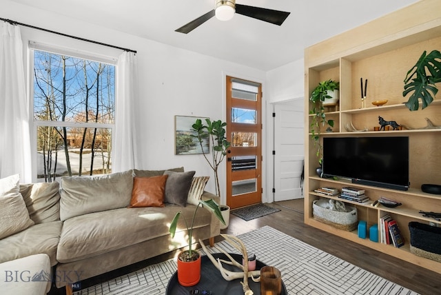 living room with plenty of natural light, wood finished floors, and a ceiling fan