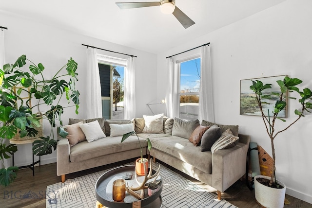 living room featuring wood finished floors, baseboards, and ceiling fan