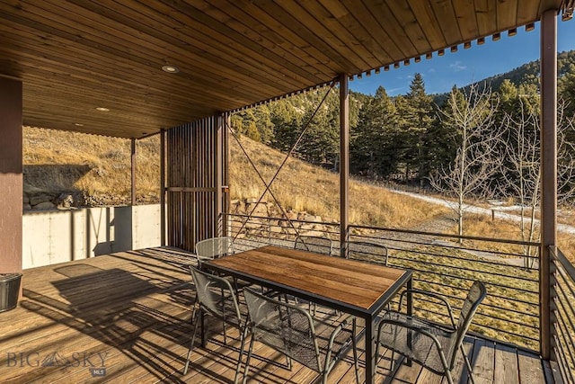 wooden deck with a forest view