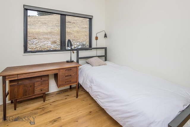 bedroom with wood finished floors