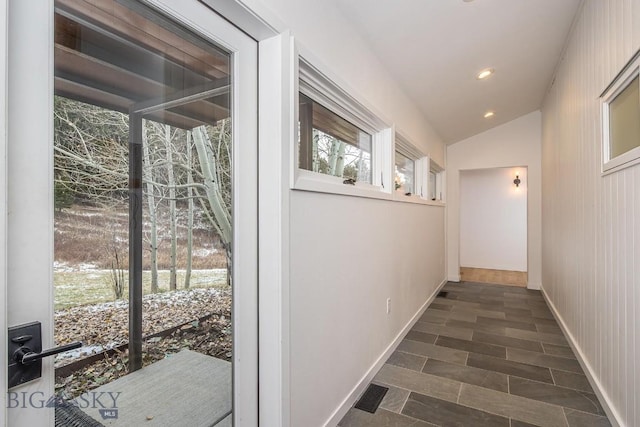 hallway with recessed lighting, baseboards, and lofted ceiling