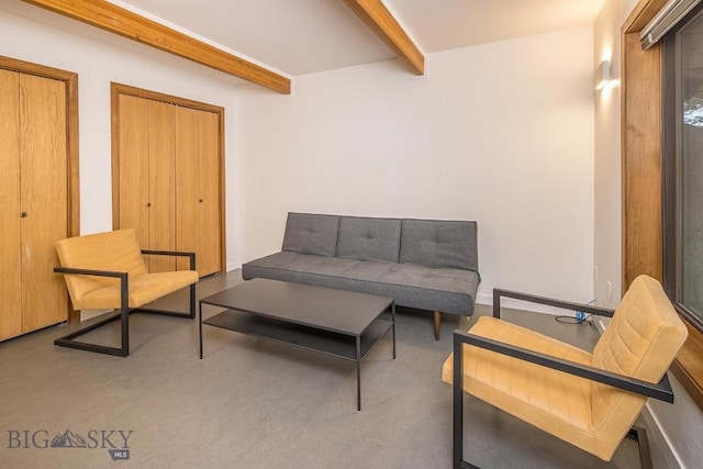 sitting room featuring beam ceiling