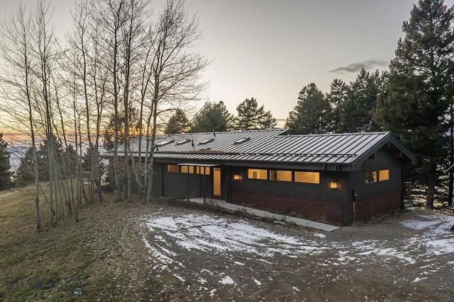 view of front of property featuring metal roof and a standing seam roof