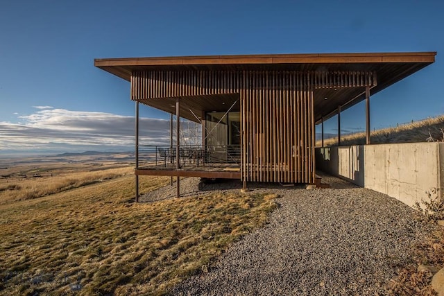 exterior space with a carport, an exterior structure, and an outdoor structure