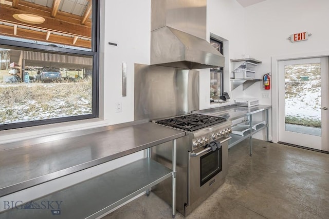 kitchen featuring open shelves, stainless steel countertops, range hood, concrete floors, and stainless steel stove