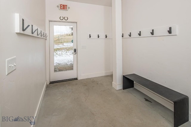 mudroom featuring concrete flooring and baseboards